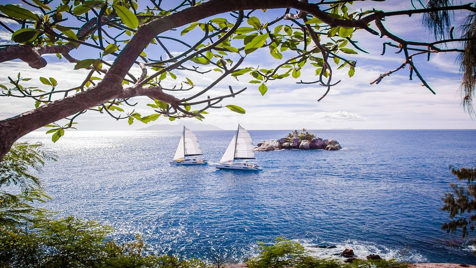 Two catamarans sailing in the Seychelles